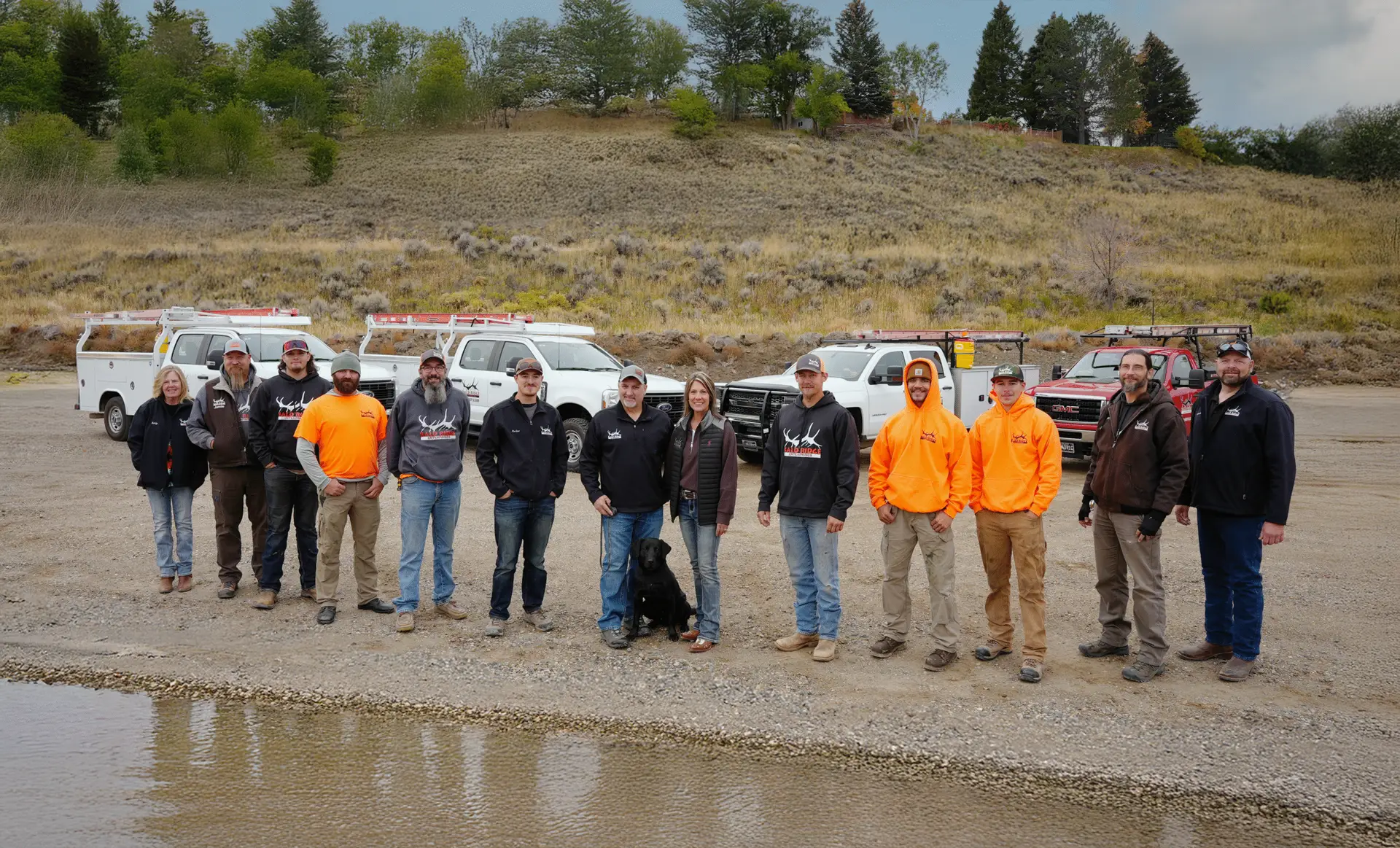 Bald Ridge team standing for a team photo in front of 4 company trucks